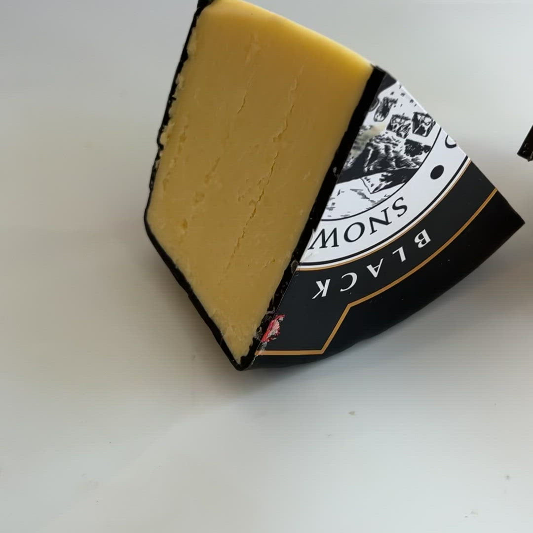 Close up video of two pieces of black bomber cheddar cheese in cheeses of muswell hill cheese shop 